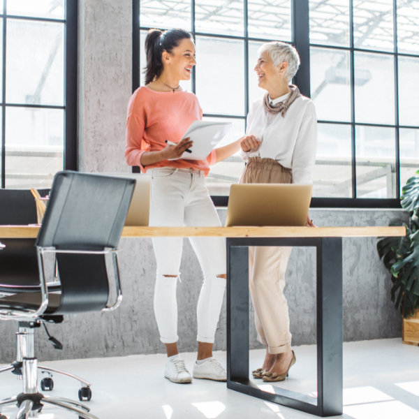 two women talking in office building